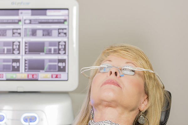Woman getting LipiFlow Thermal Pulsation treatment for dry eye