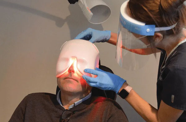 Patient getting Low-Level Light Treatment (LLLT) treatment for dry eye management at LaCroix