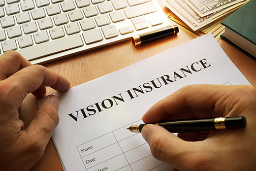 Person filling out vision insurance form for LaCroix Eye Care in Mt. Clemens, MI
