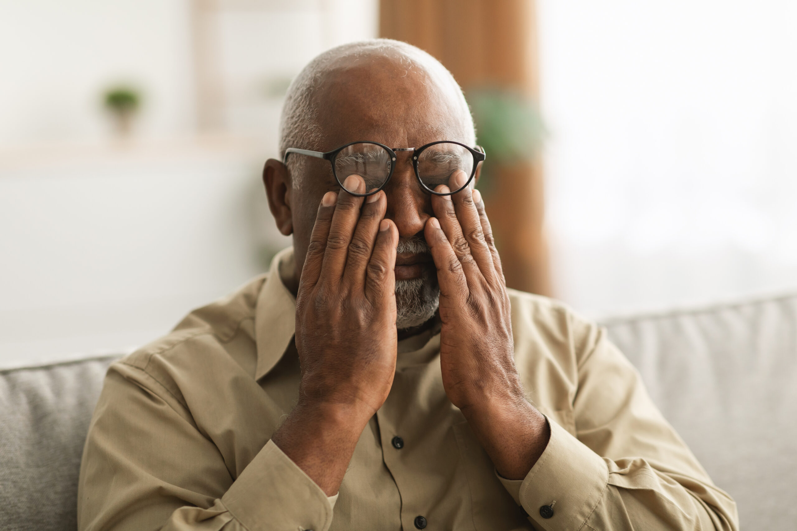 Man Rubbing His Eyes